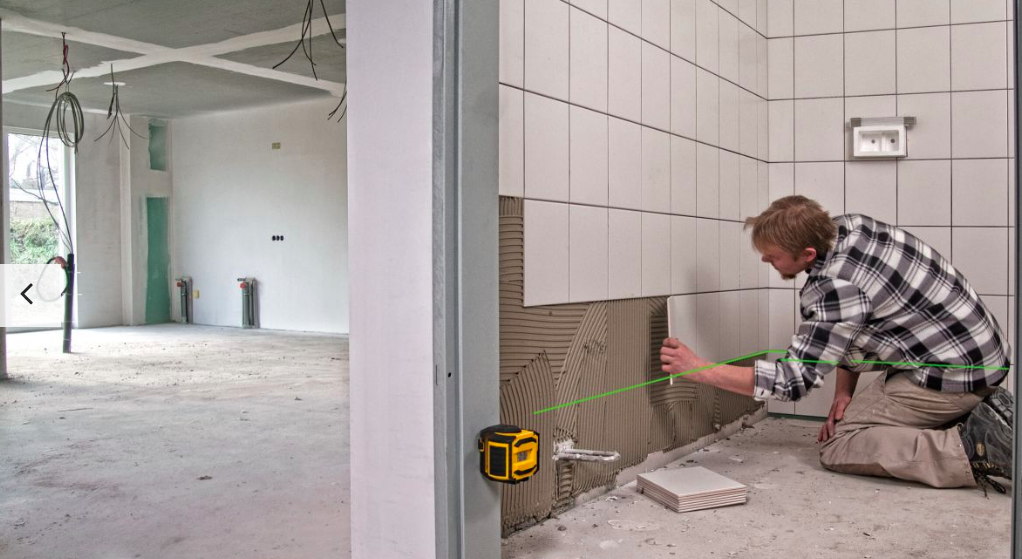 Worker Applying Tile Stabila